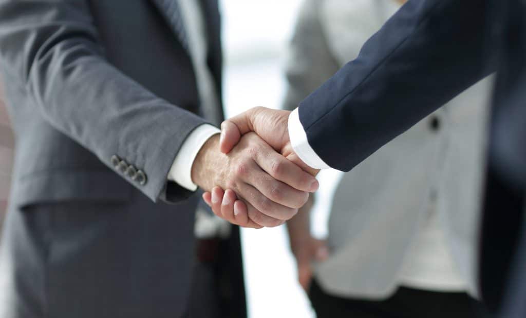 Two business men shaking hands.